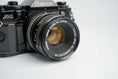 Load image into Gallery viewer, Canon A-1 Black – Vintage 35mm SLR with Canon FD 50mm f/1.8 Lens – Tested and Working
