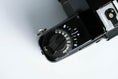 Load image into Gallery viewer, 'Praktica BCA + Prakticar 50mm f/2.4 + free 35mm film – Electronic vintage SLR'
