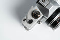 Load image into Gallery viewer, Praktica L + Carl Zeiss Jena 50mm f/2.8 + Free 35mm film – Classic DDR SLR
