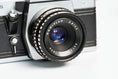 Load image into Gallery viewer, 'Praktica MTL 5 + Domiplan 50mm f/2.8 + free 35mm film – Reliable vintage SLR'
