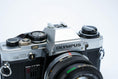 Load image into Gallery viewer, Olympus OM-10 – Zuiko 50mm f/1.8 + Free Kodak Gold 35mm Film
