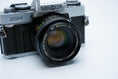 Load image into Gallery viewer, Minolta XG-1 + MC Rokkor-PF 50mm f/1.7 + free Kodak Gold 35mm film
