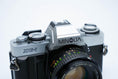 Load image into Gallery viewer, Minolta XG-1 + MC Rokkor-PF 50mm f/1.7 + free Kodak Gold 35mm film
