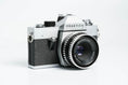 Load image into Gallery viewer, Praktica L + Carl Zeiss Jena 50mm f/2.8 + Free 35mm film – Classic DDR SLR
