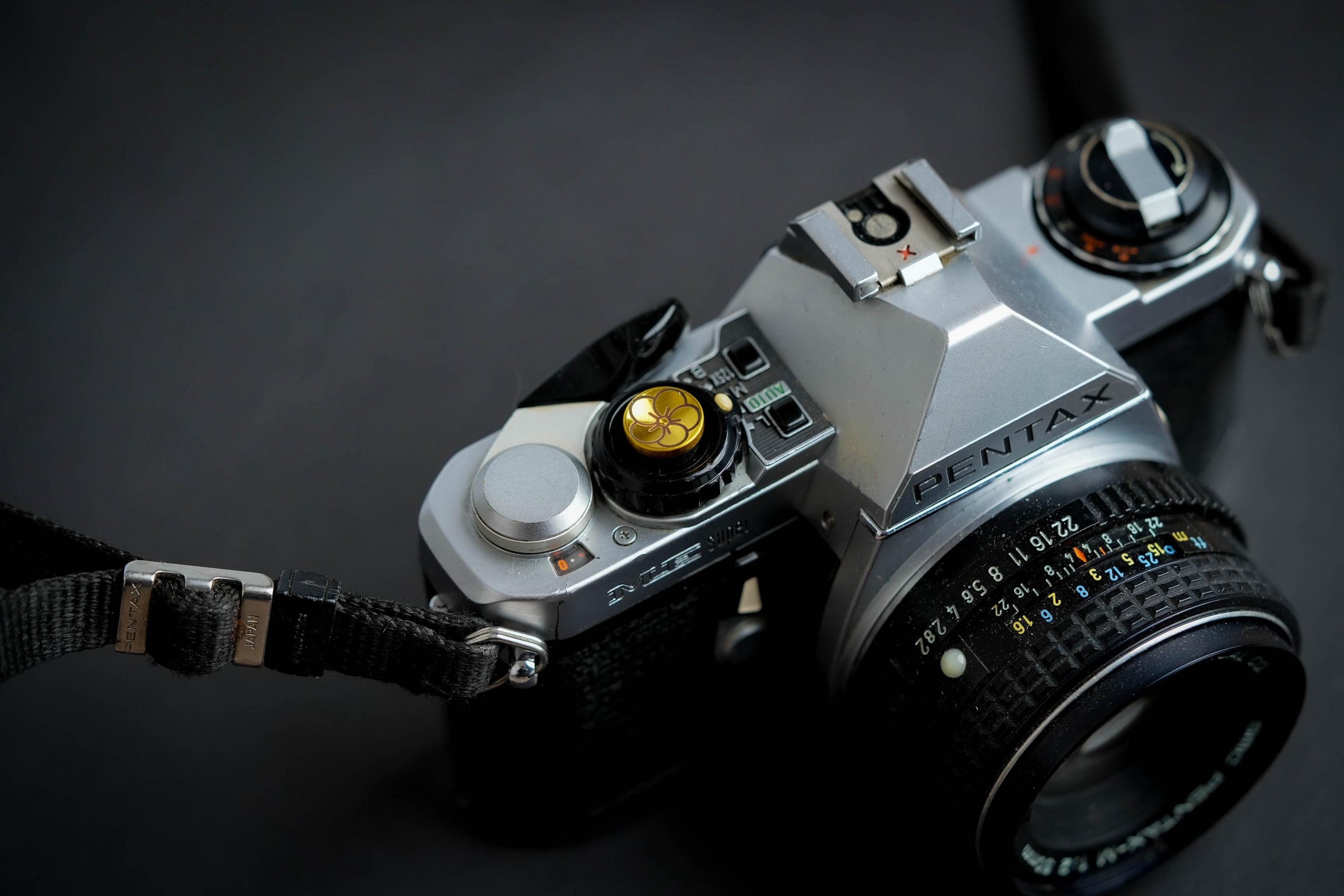 "Shutter button with flower engraving: Give your camera a luxury upgrade with this brass shutter button!"