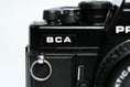 Load image into Gallery viewer, 'Praktica BCA + Prakticar 50mm f/2.4 + free 35mm film – Electronic vintage SLR'

