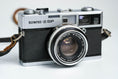 Load image into Gallery viewer, Olympus 35 SP + G. Zuiko 42mm f/1.7 + Free Kodak Gold – Rare rangefinder | Fully working | With learning cover and lens cap
