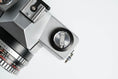 Load image into Gallery viewer, Praktica L + Carl Zeiss Jena 50mm f/2.8 + Free 35mm film – Classic DDR SLR
