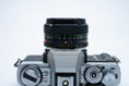 Load image into Gallery viewer, Minolta XG-1 + MC Rokkor-PF 50mm f/1.7 + free Kodak Gold 35mm film
