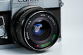 Load image into Gallery viewer, Canon FT QL + Tokina RMC 28mm f/2.8 – Fully functional + free 35mm film
