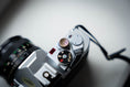 Load image into Gallery viewer, Handmade Engraved Relax Button – Vintage & Modern Camera Accessory

