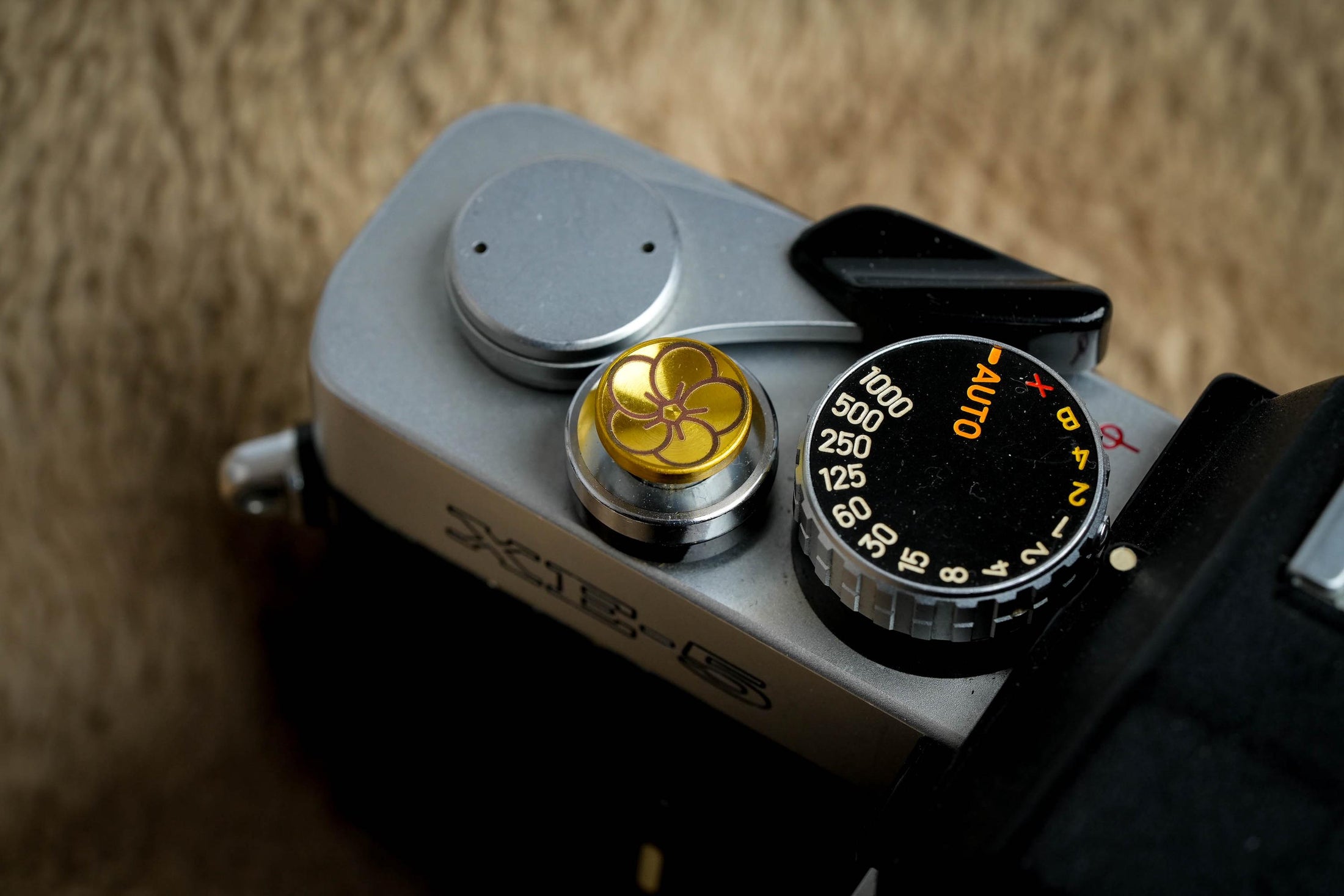 "Shutter button with flower engraving: Give your camera a luxury upgrade with this brass shutter button!"