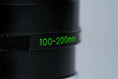 Load image into Gallery viewer, Canon FD 100-200mm f/5.6 S.C. Telezoom – Vintage Classic with Montreal 1976 Lens Hood
